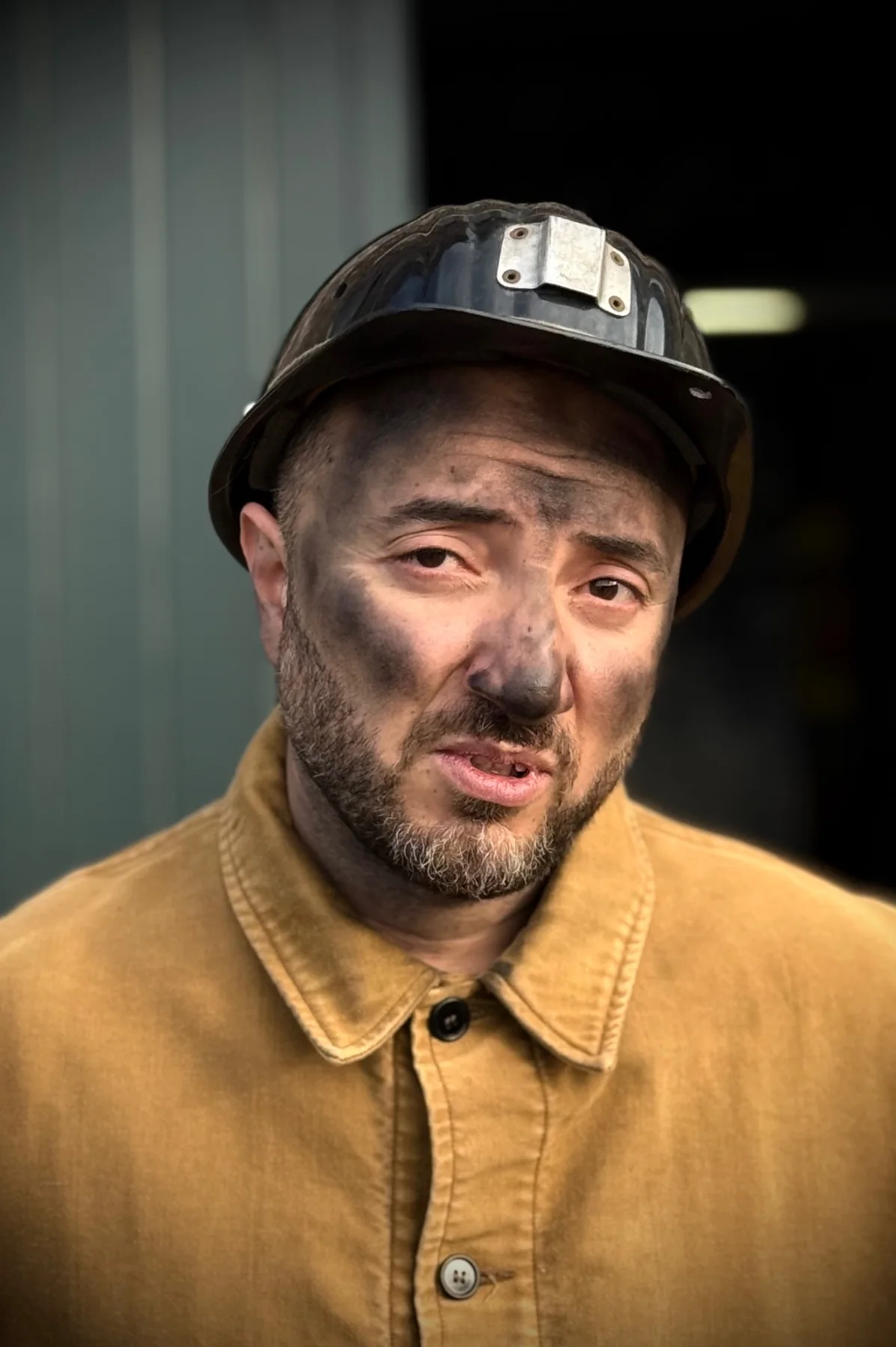 Cyrus portraying a character in work clothes